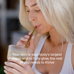 Smiling woman drinking Equi Beauty Formula to support healthy glowing skin