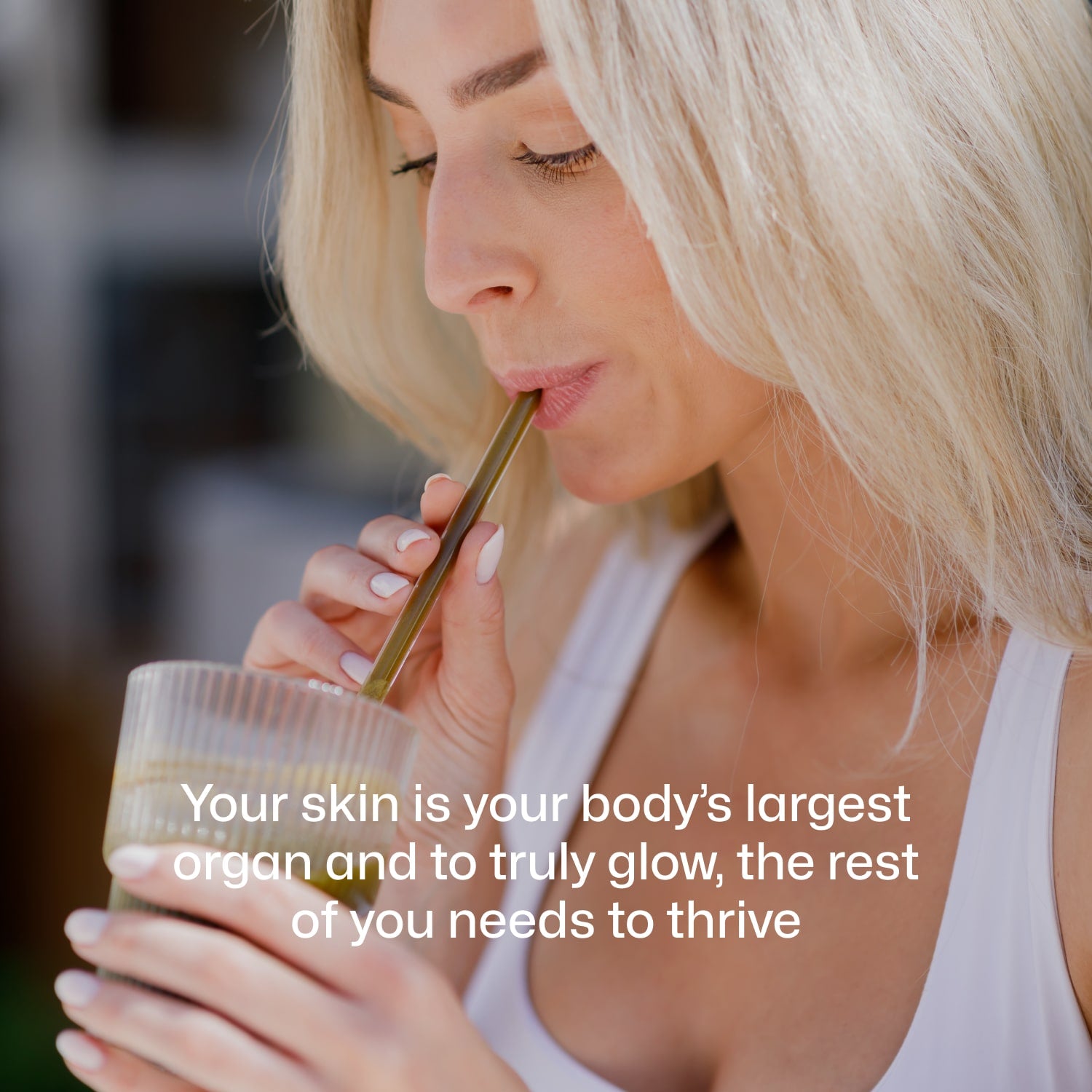 Smiling woman drinking Equi Beauty Formula to support healthy glowing skin