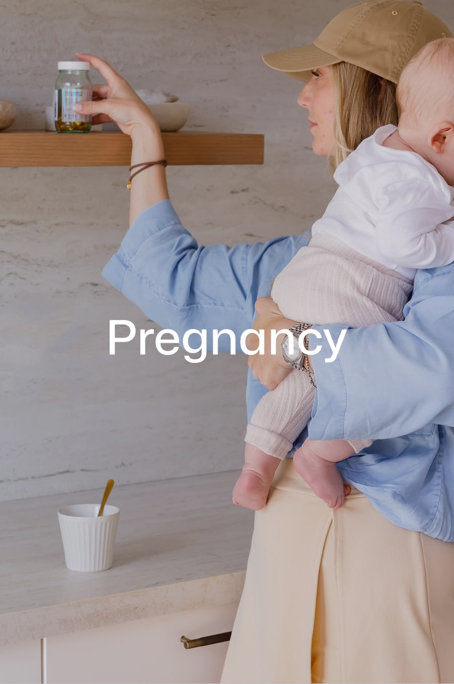 Mother reaching for Equi Pregnancy Formula supplement while holding her baby