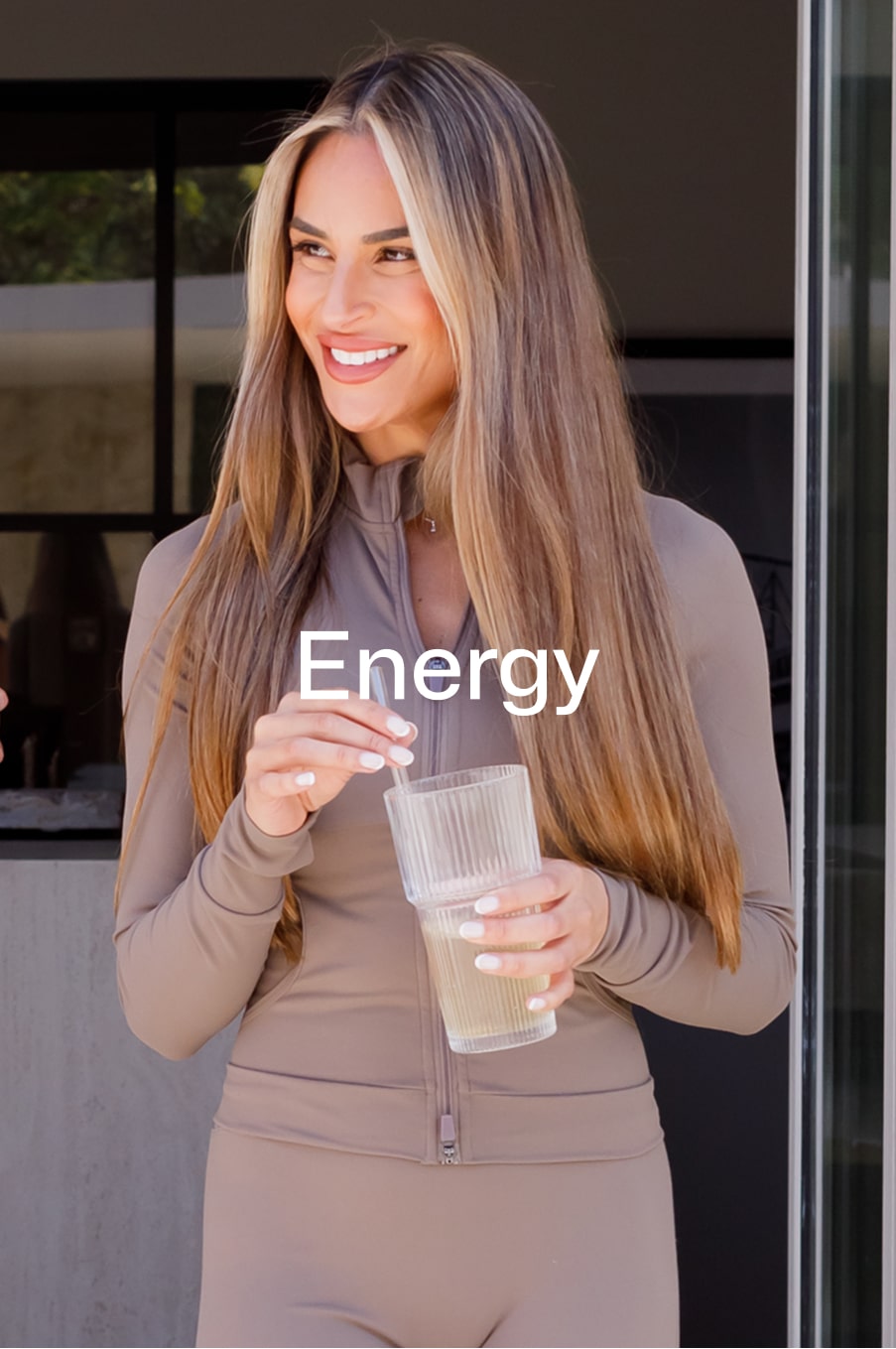 Woman smiling and holding a glass of Equi Wellness Formula for daily energy support